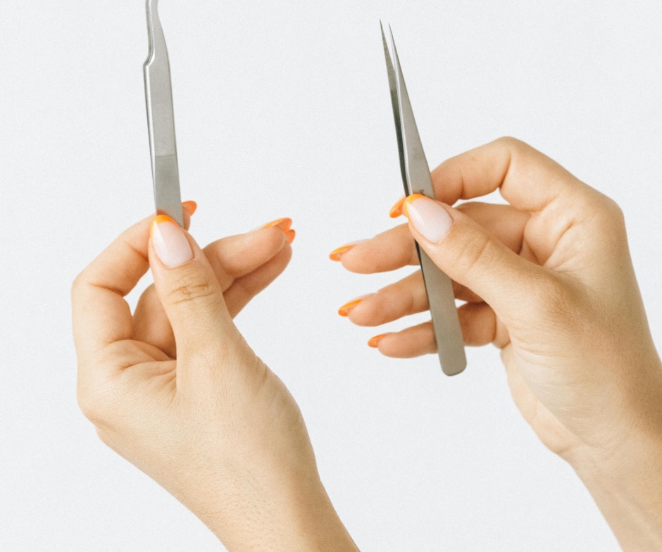 hands holding surgical tools