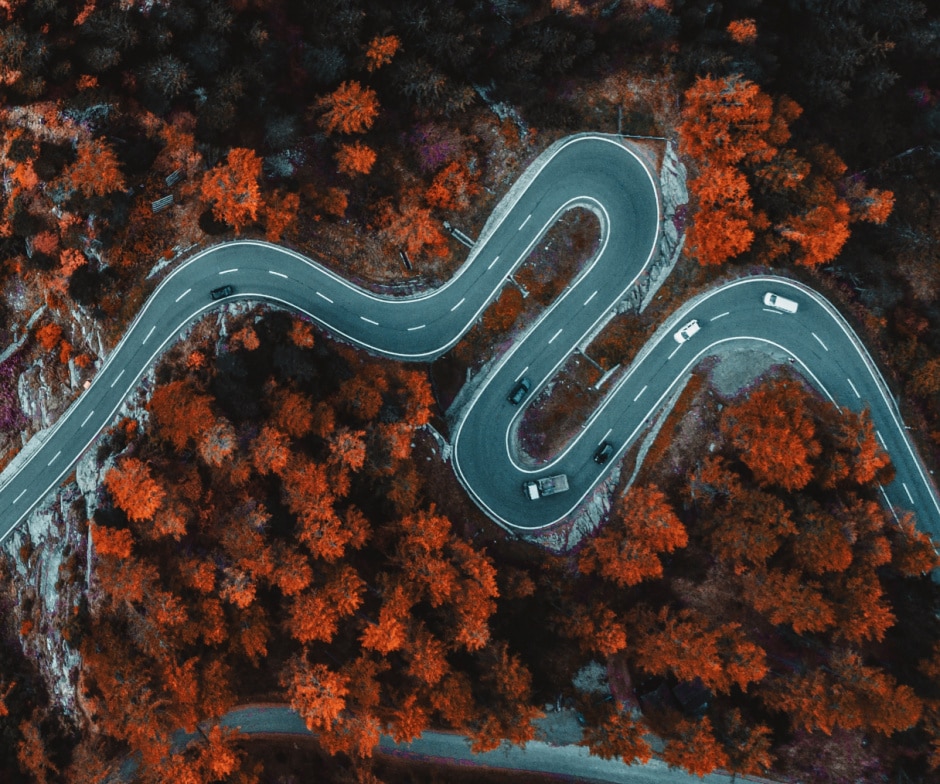 drone picture shot of road in middle of mountains