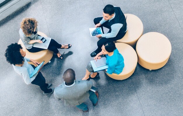 group of people discussing in a break room