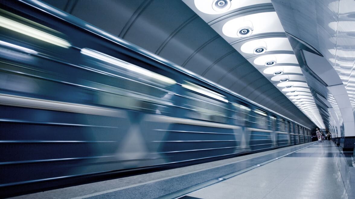 train going fast in train station
