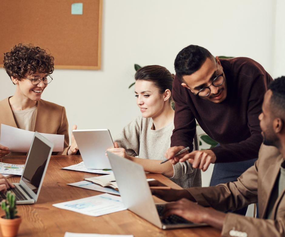 people sitting in office room and talking to each other