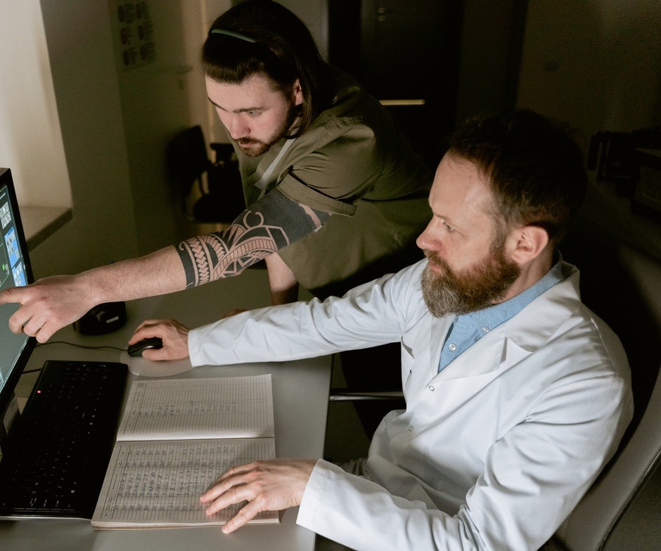 Two people working on a computer