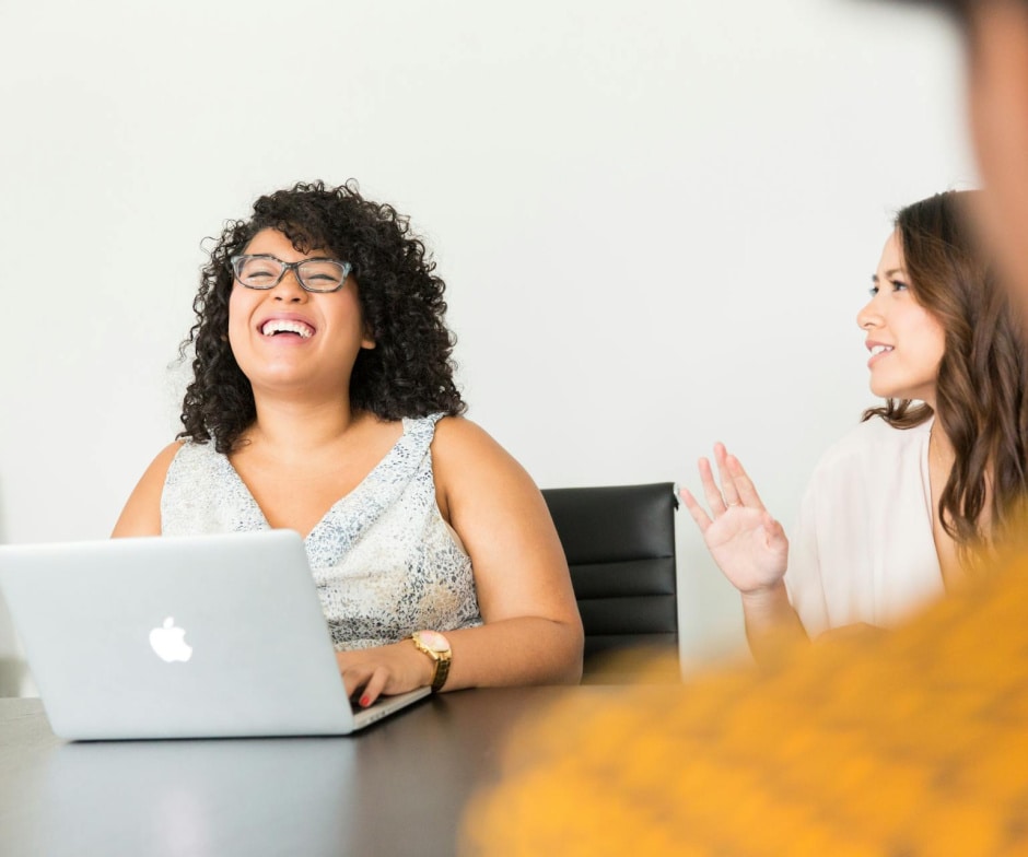 people sitting in conference room talking and laughing
