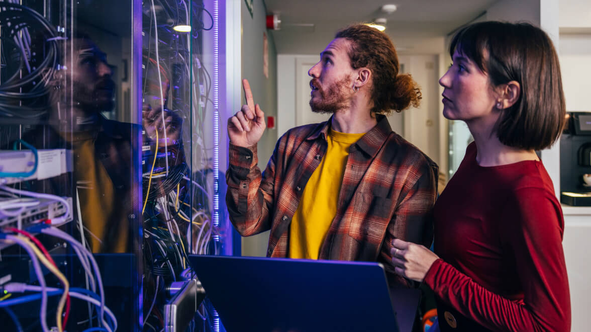 Man and woman fixing network hardware