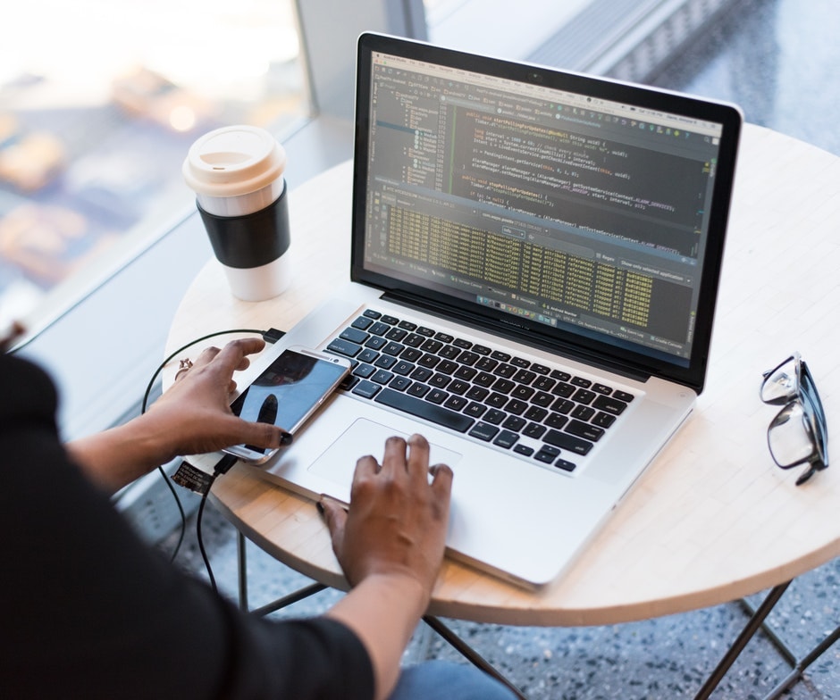 over-the-shoulder view of person working on laptop