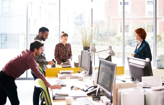 group of people discussing in an office
