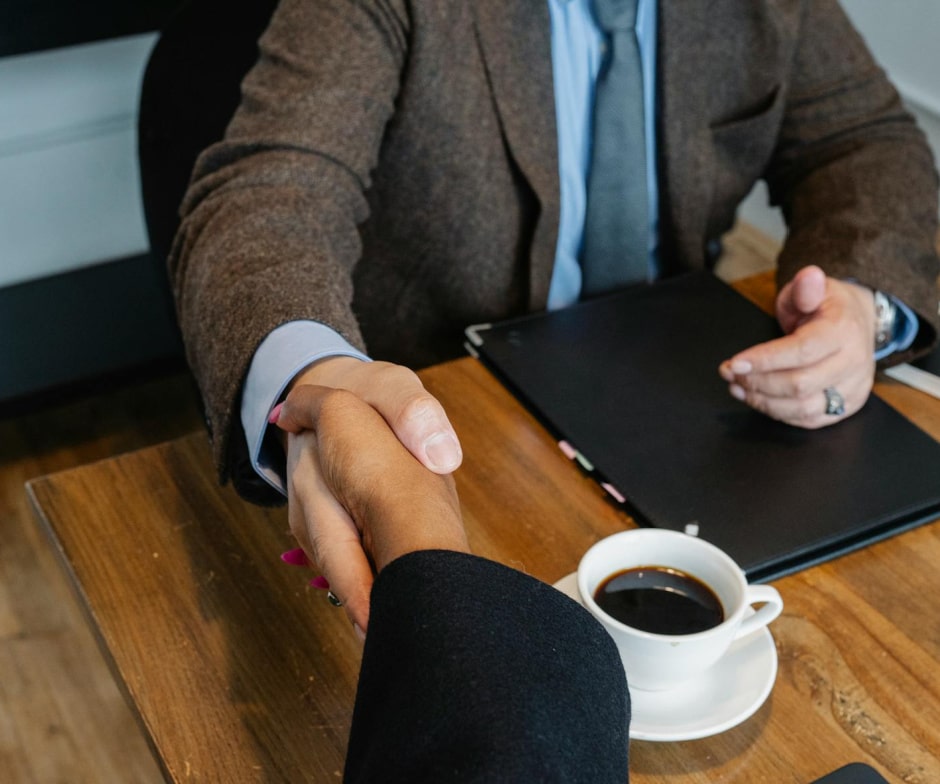 professional handshake across a table