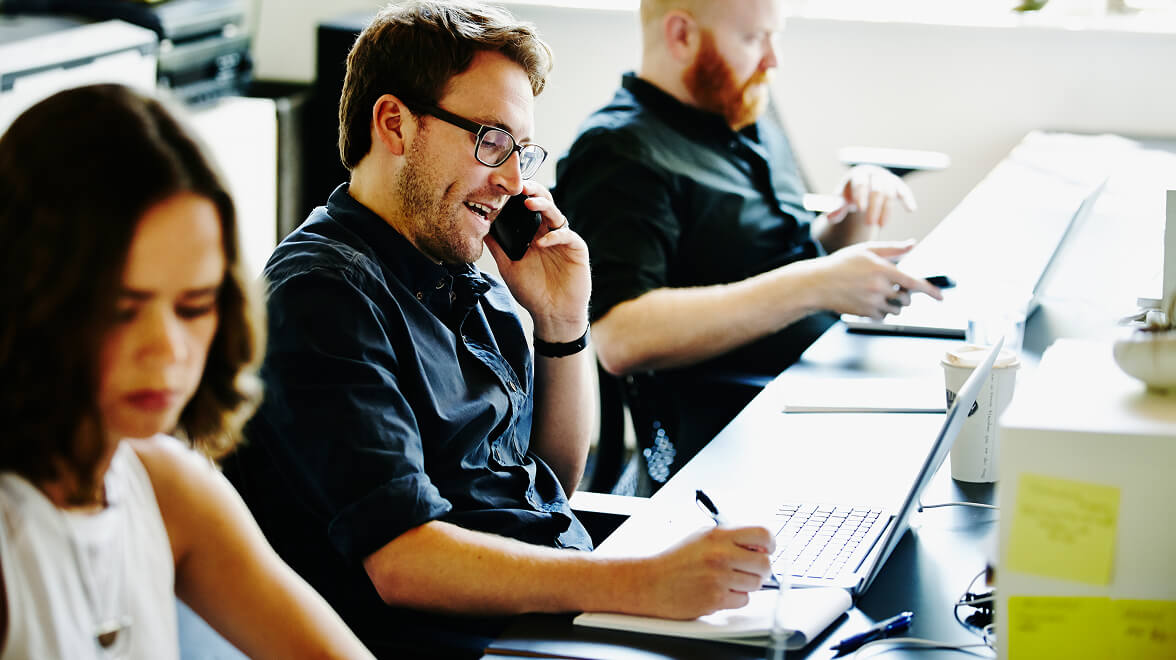 Couple of people sitting and working in the office