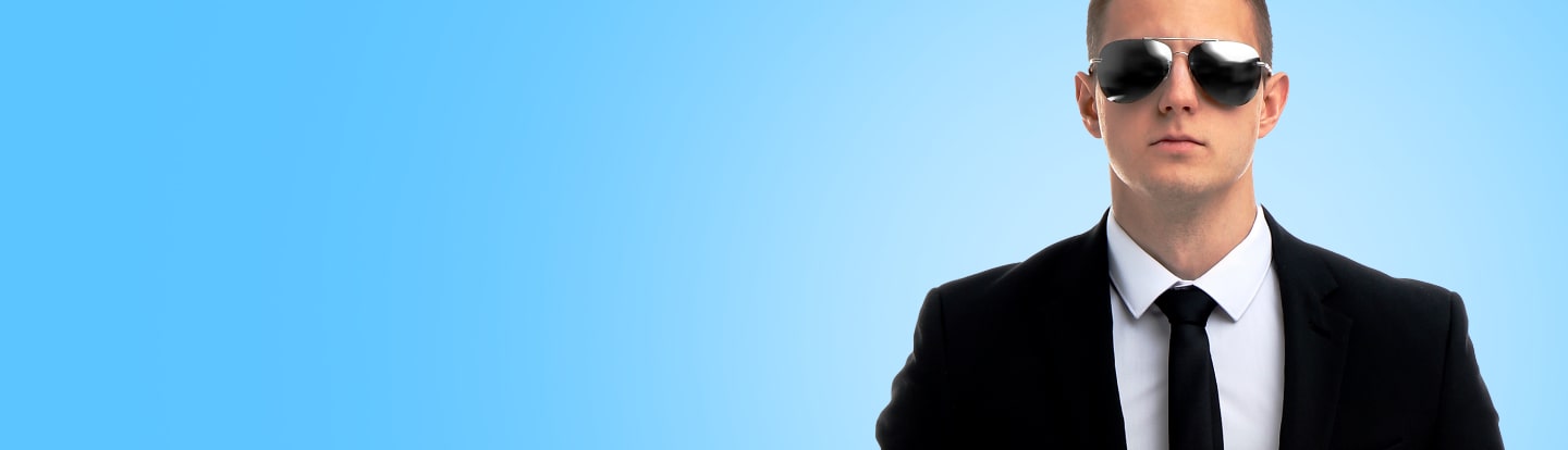 Person in sunglasses and suit on a blue background