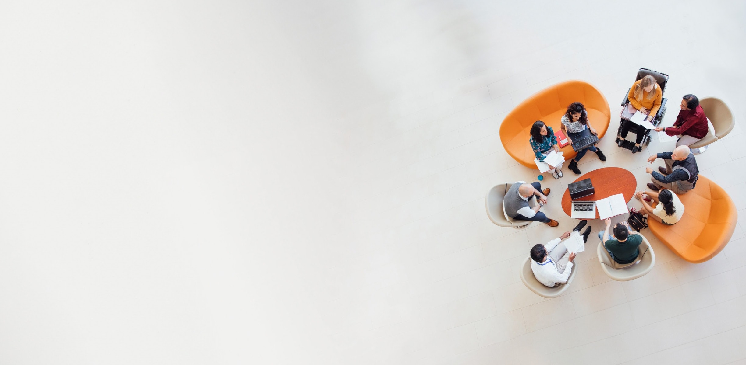 Employees working in a group on a meeting table.