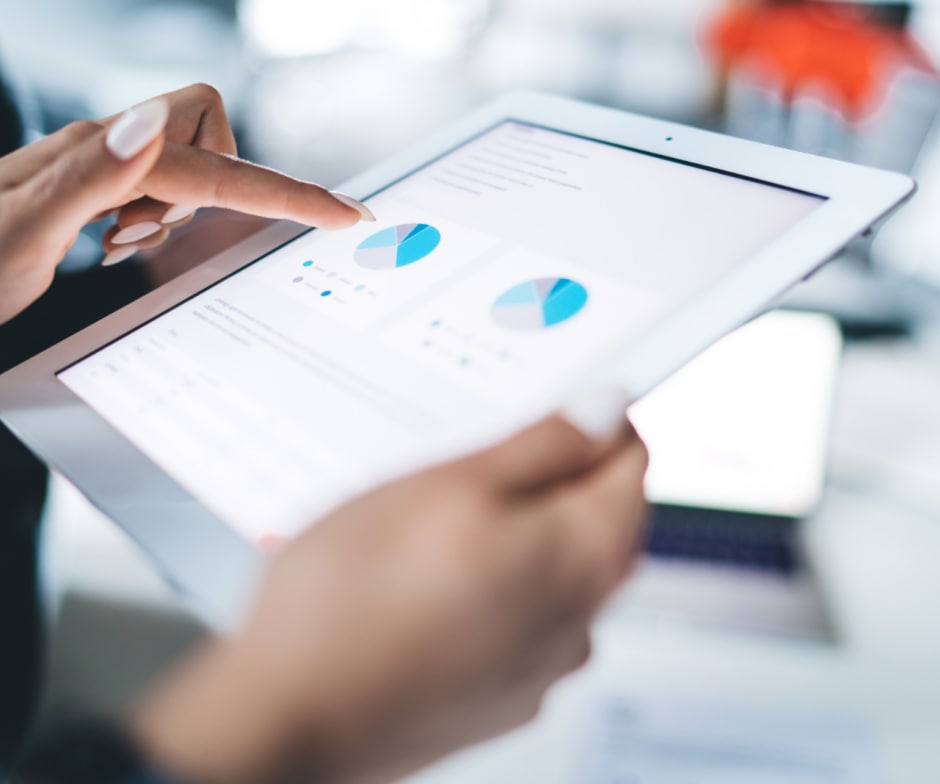 person looking at pie charts in tablet screen
