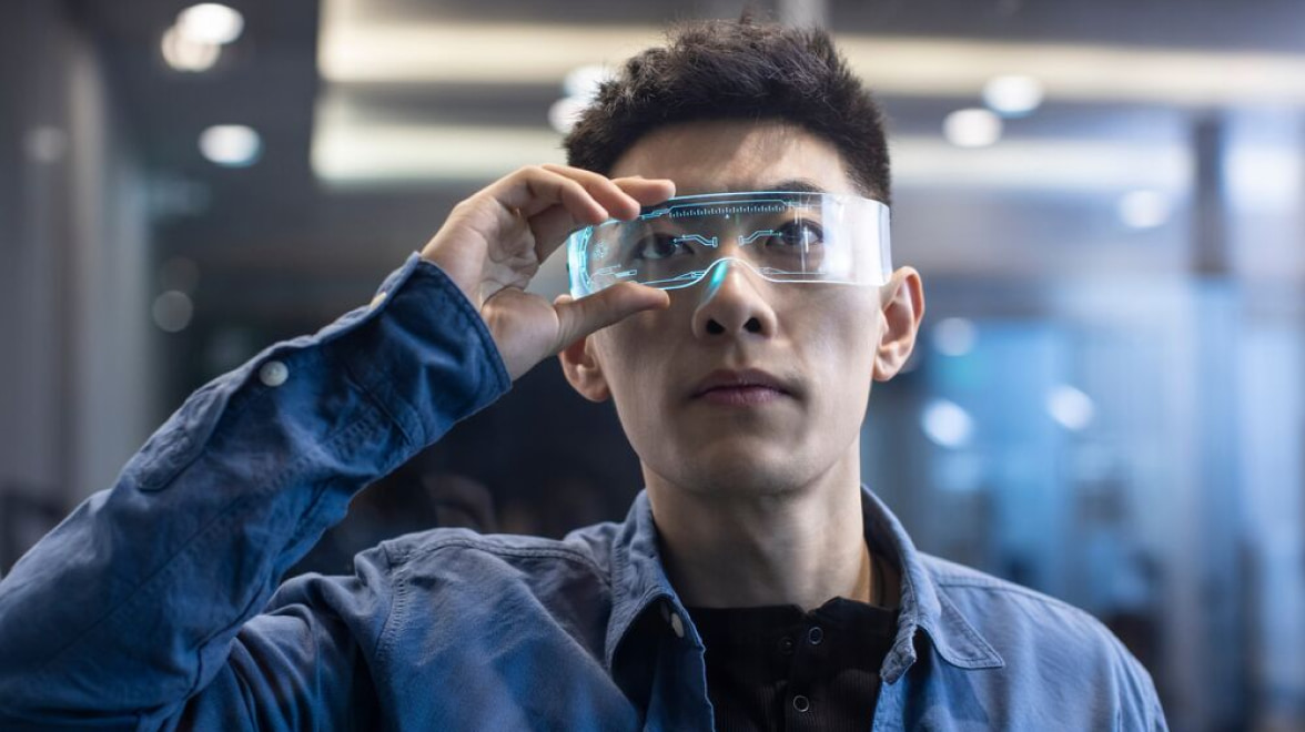 Man looking at screen through glasses
