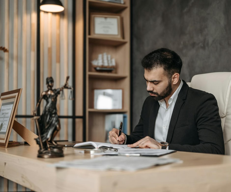 person sitting on desk and writing
