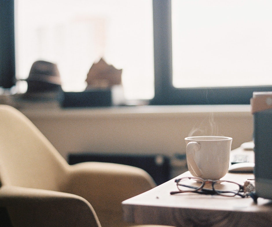 office room with coffee cup and glasses on table