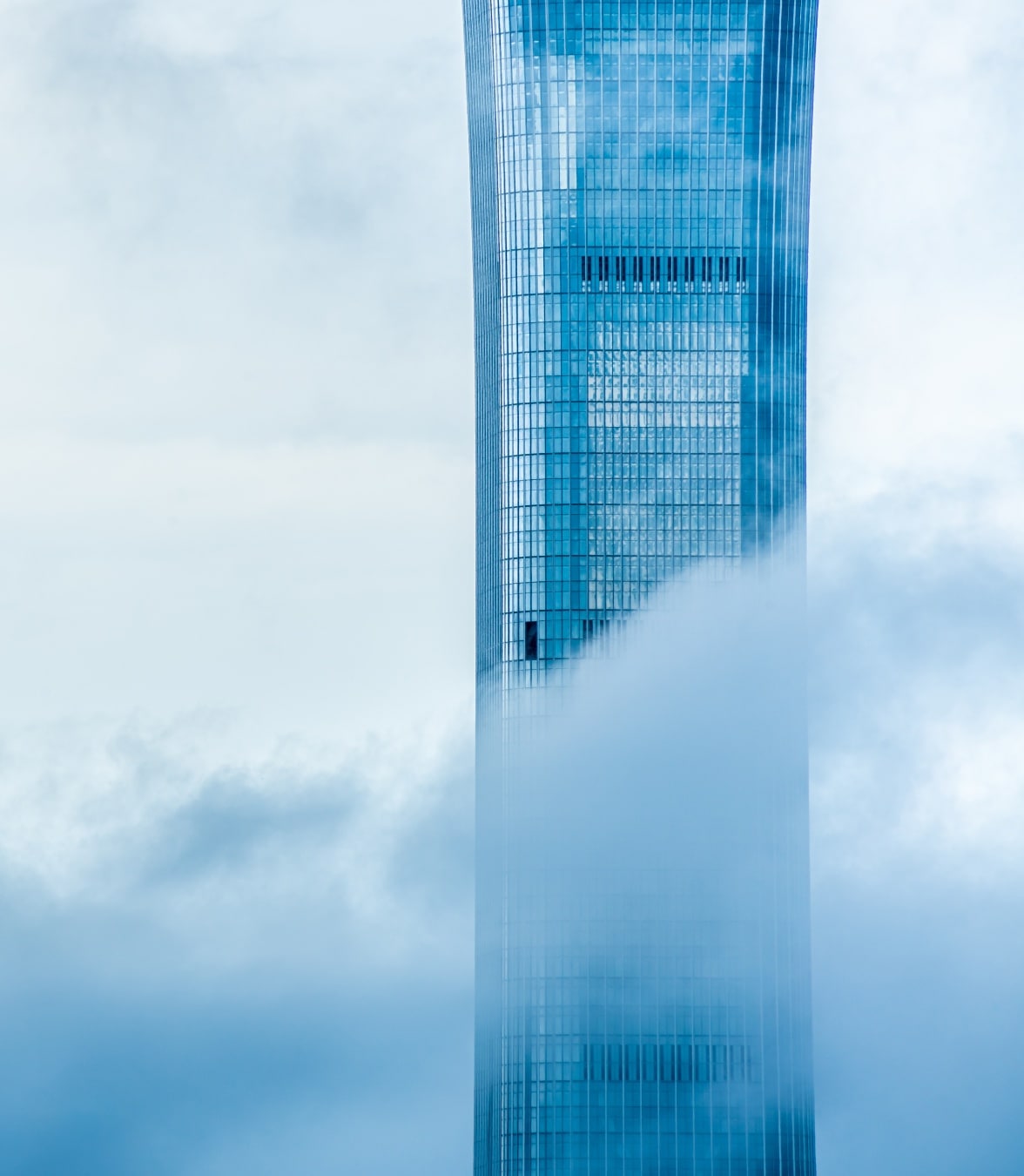 highrise surrounded by clouds