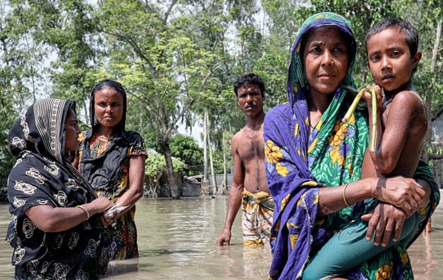 People standing in a flooded area