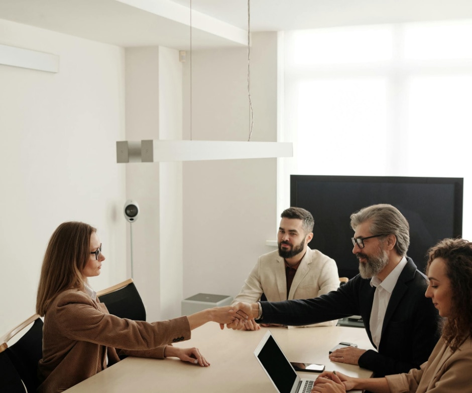 people shaking hands in a meeting