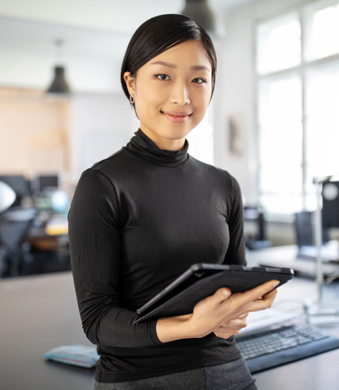 Professional smiling holding tablet