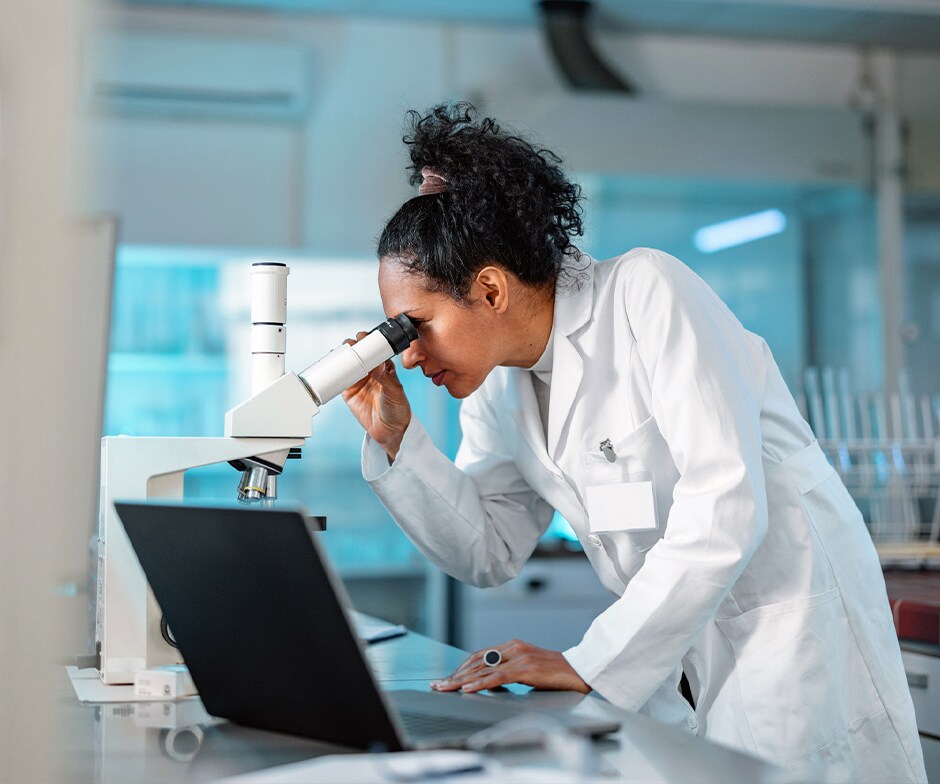 scientist using microscope
