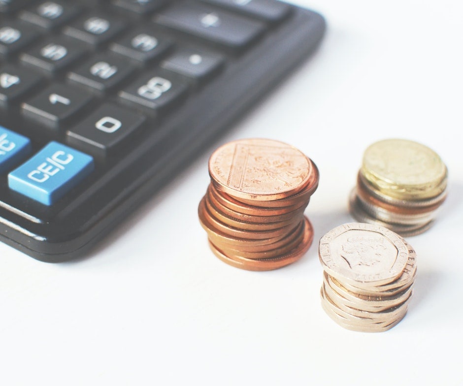 coins and a calculator on a desk
