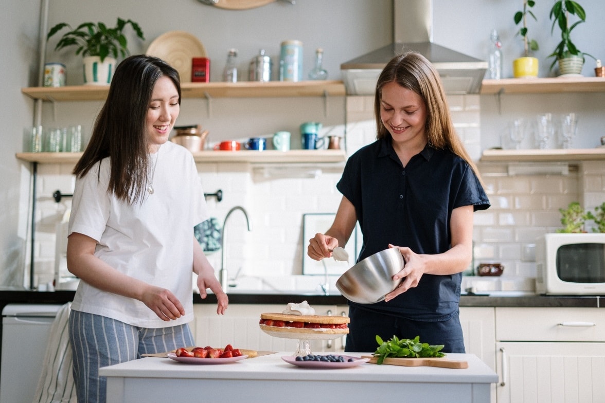 two women making a strawberry shortcake