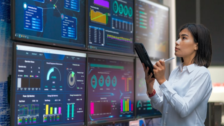 woman viewing data on multiple screens