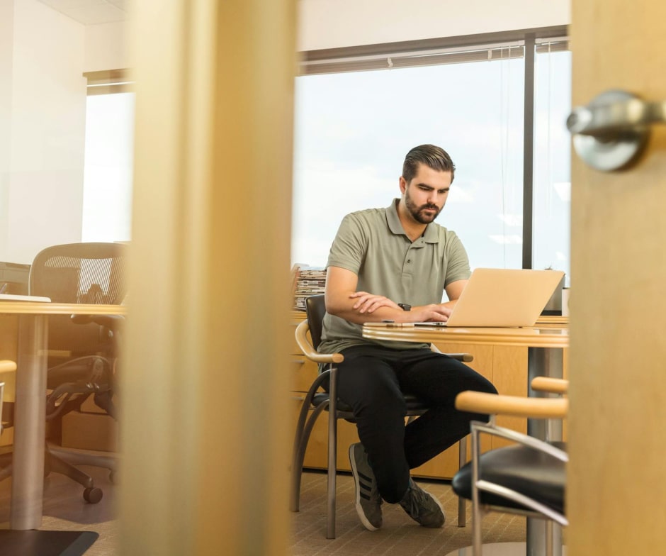 Person sitting and working using a laptop