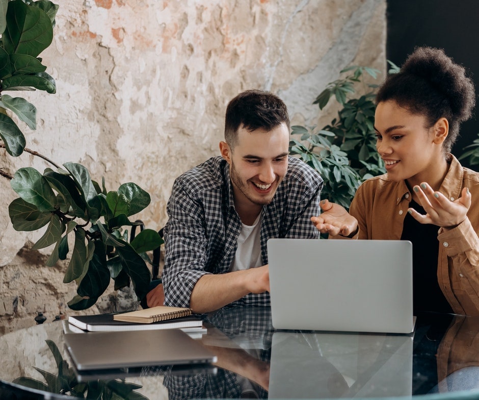 a couple looking at a laptop