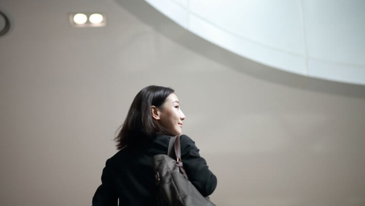 person wearing bag and looking on side