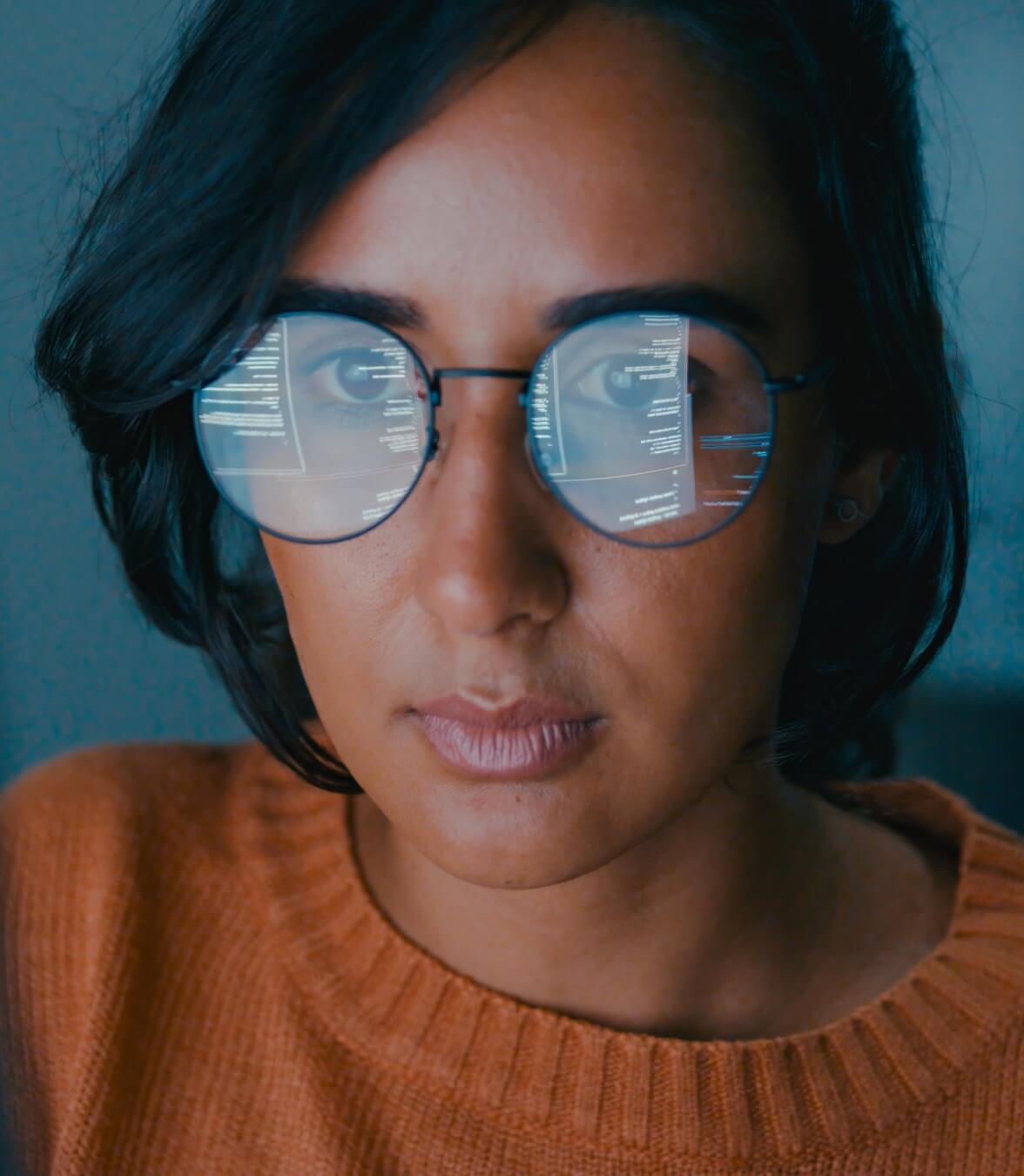 person wearing glasses and looking at the monitor