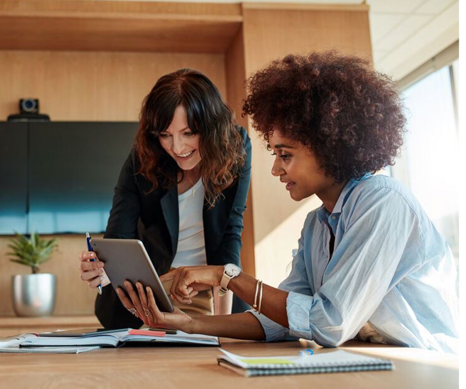 two people working on laptop in a office