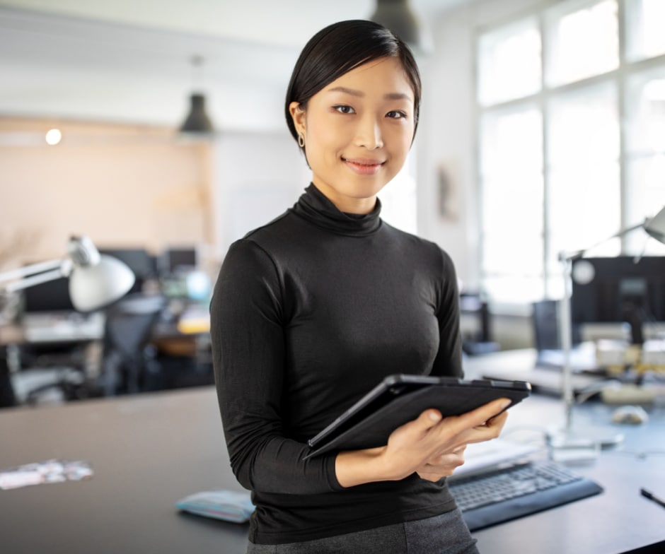 Person standing with tablet in hands