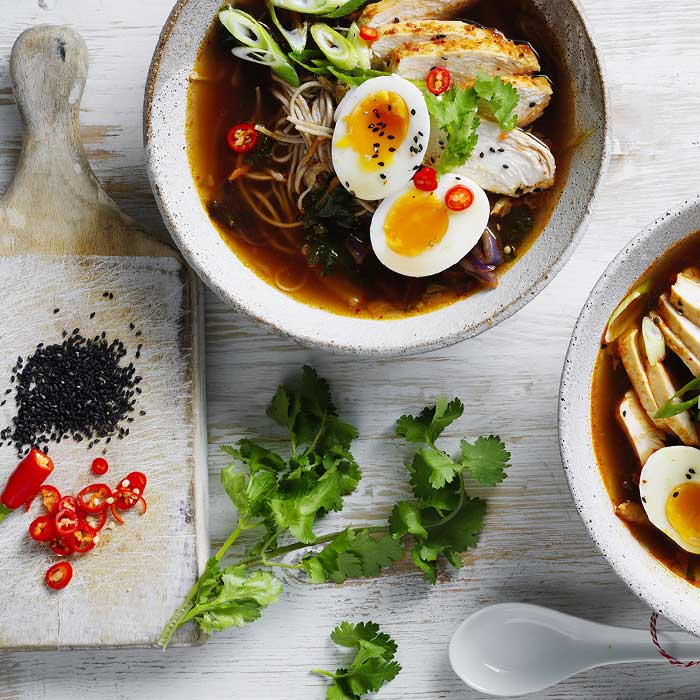 chicken ramen in bowls with garnish