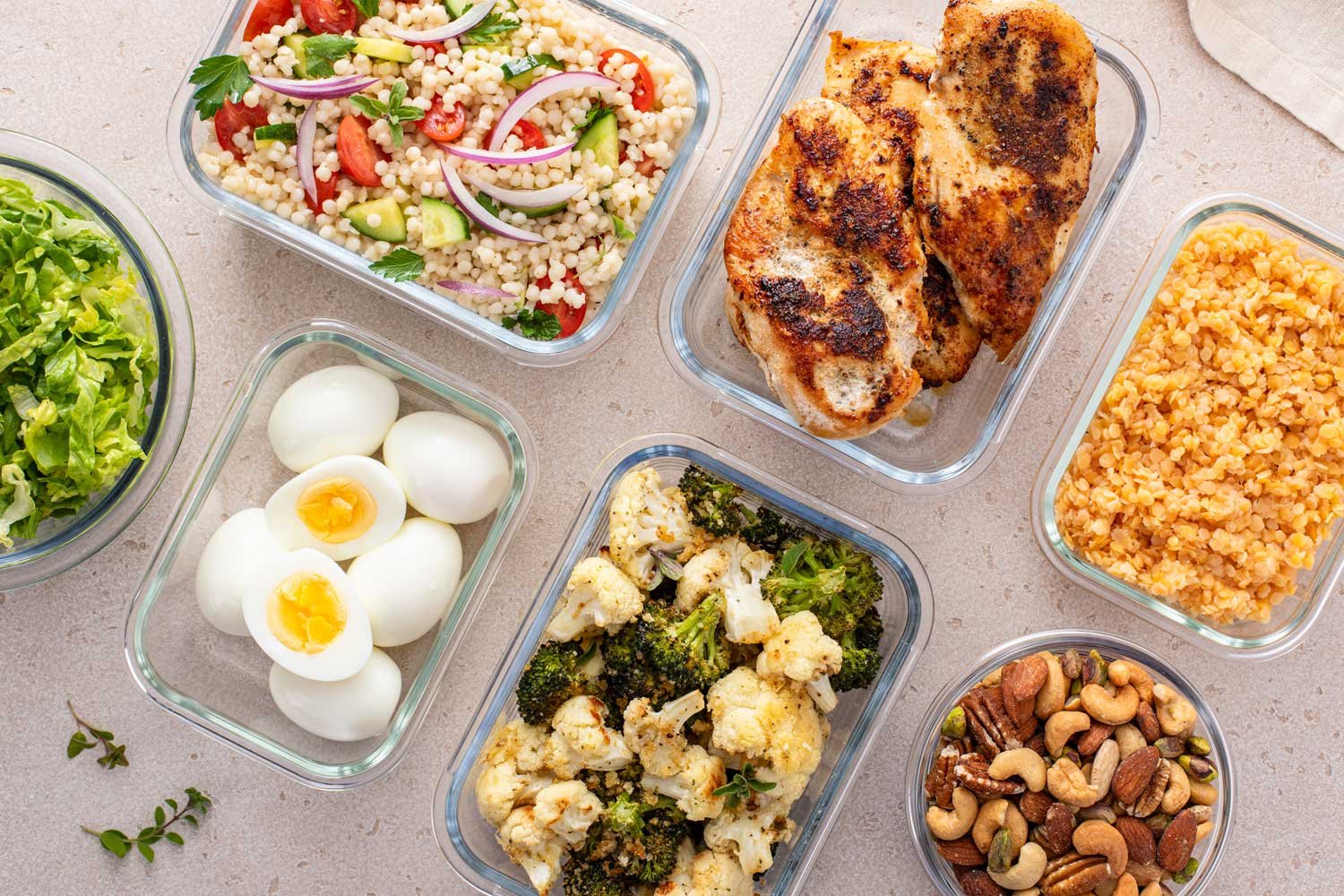 Healthy meal prep containers with protein, vegetables and whole grains