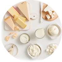 Different types of cheese on a white surface