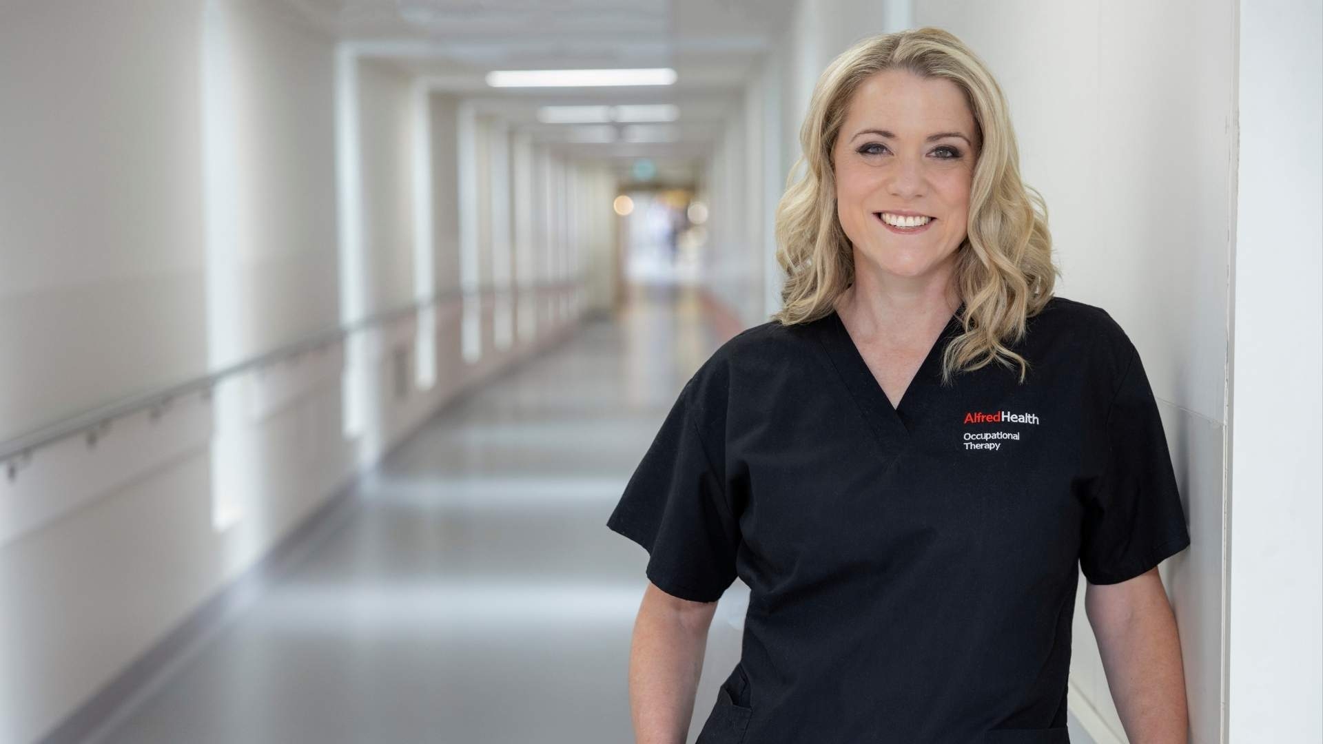 Heart disease researcher Professor Natasha Lannin standing in hospital ward smiling