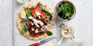 A lamb souvlaki with lot of fresh vegtables