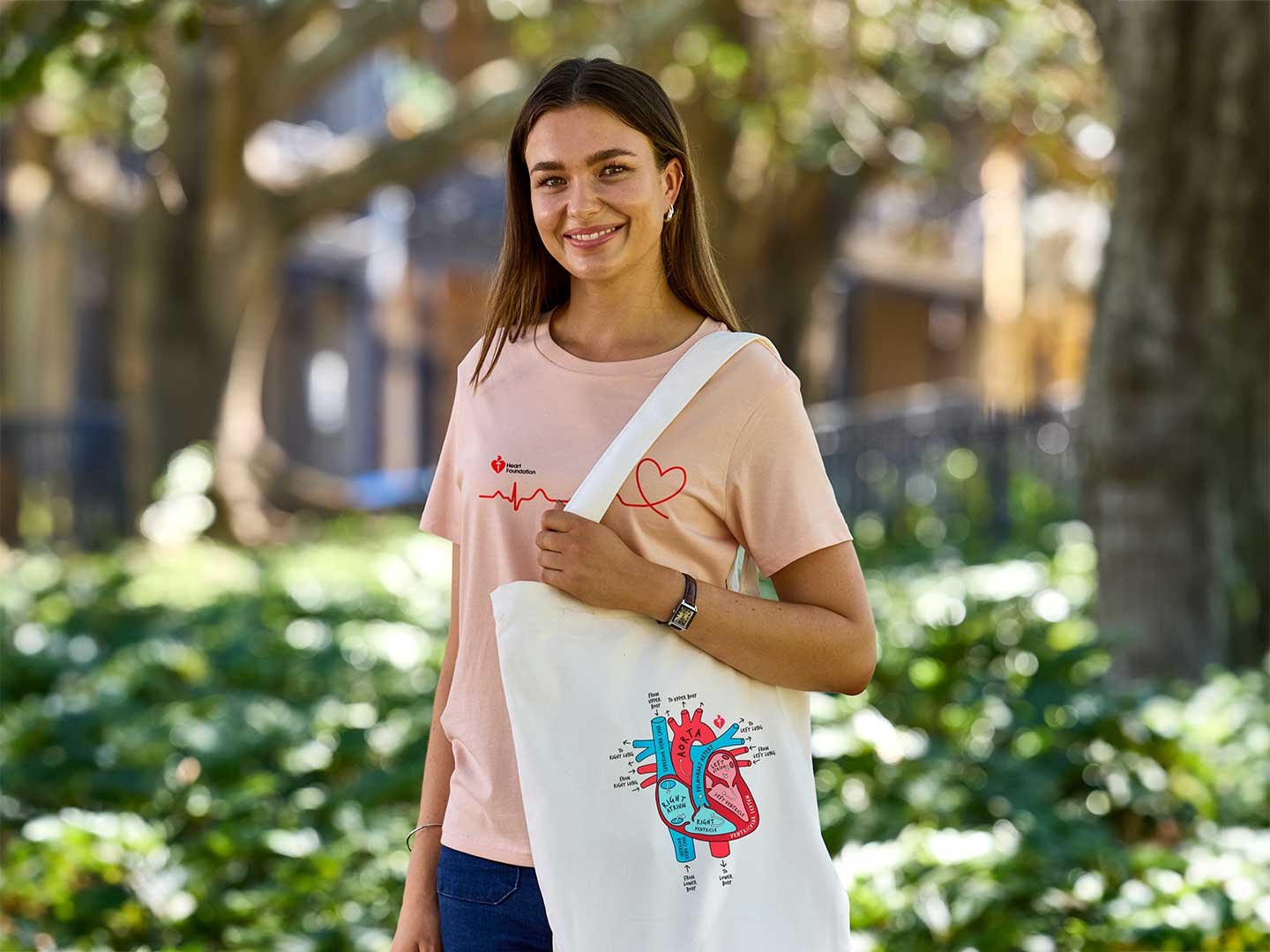 Smiling woman wearing Heart Foundation Shop merch