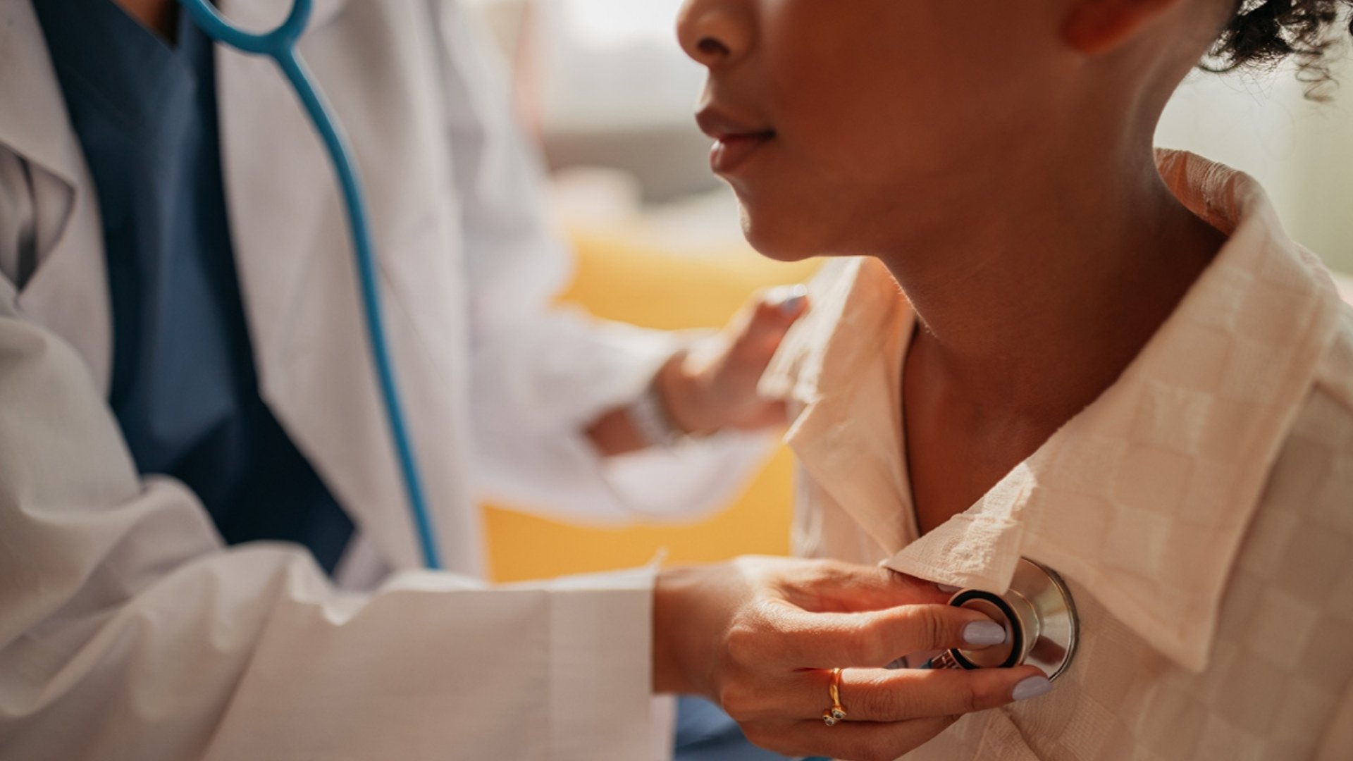 Doctor checking patient's heart