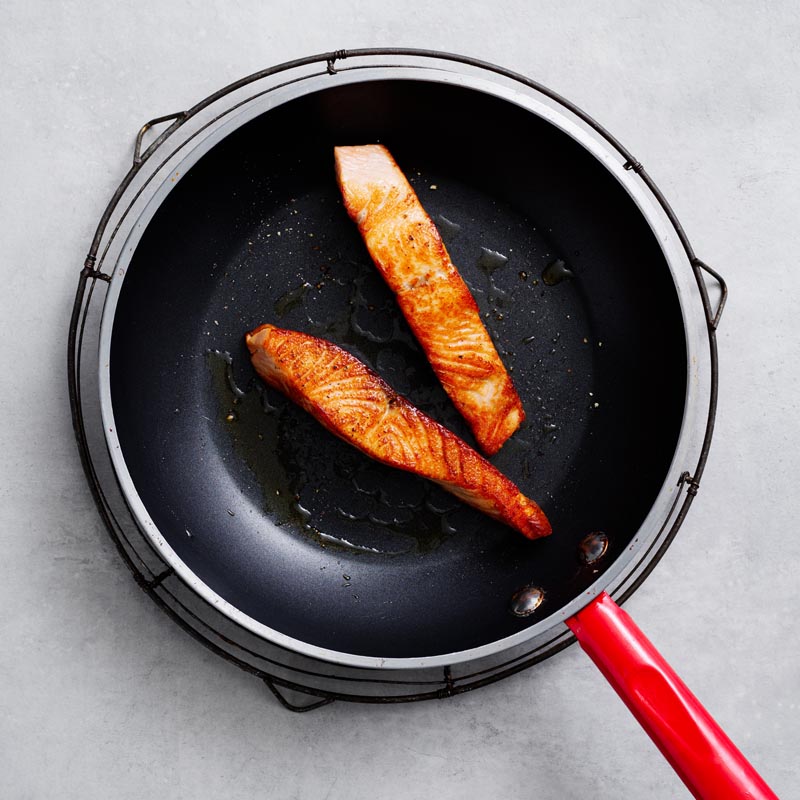 Salmon cooking in a pan