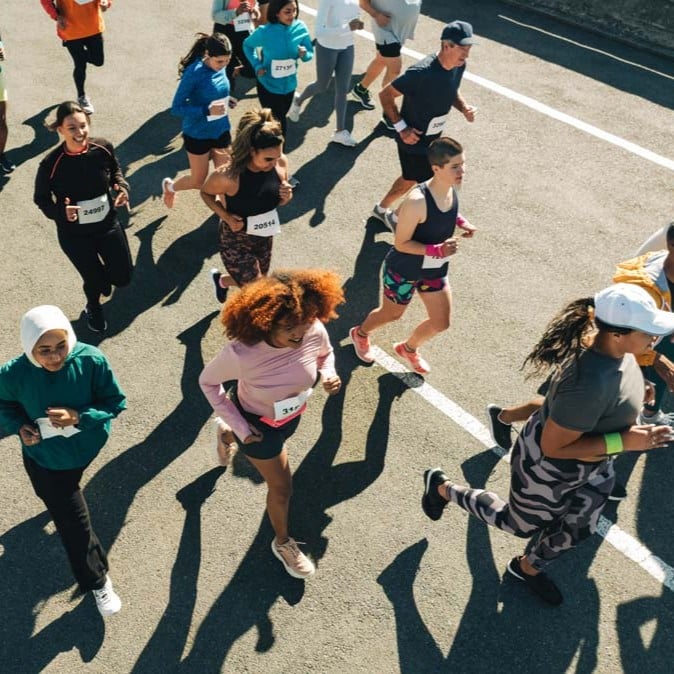 Participants taking part in a community running event on a city street.