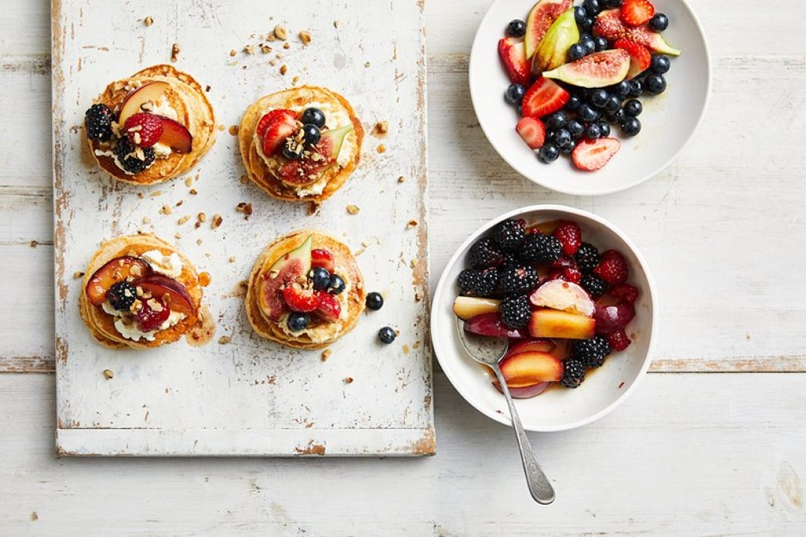 Table with small fruit plates and berry bowl.