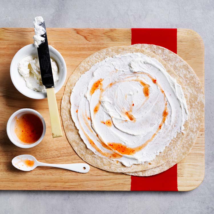 Wraps spread with ricotta and sweet chilli sauce