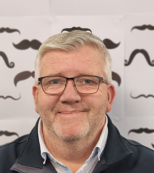 Chris smiling, sharing heart stories about his heart attack and lifestyle change