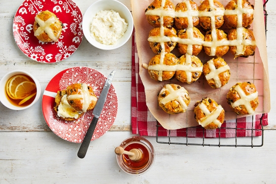 Delicious hot cross buns with sweet icing on a table