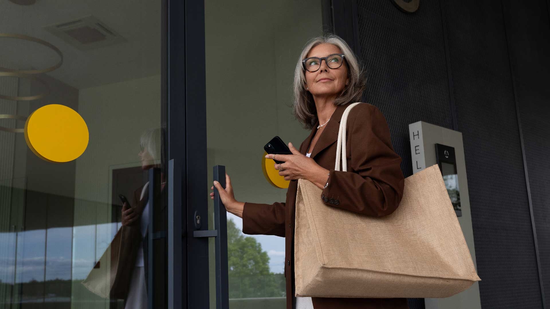 A woman is opening door to place of business, going back to work