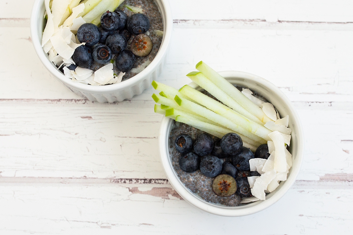 two bowls filled with fresh blueberries and celery sticks