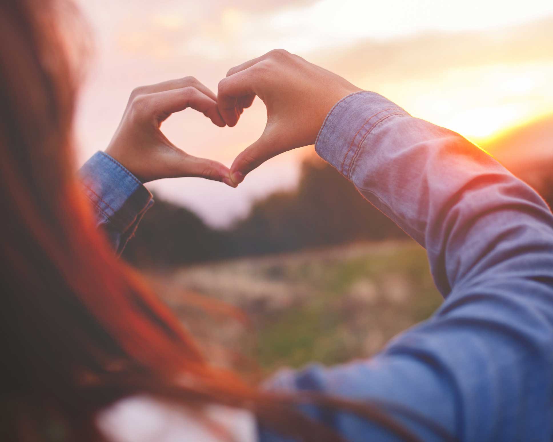 Heart hands to the sunset
