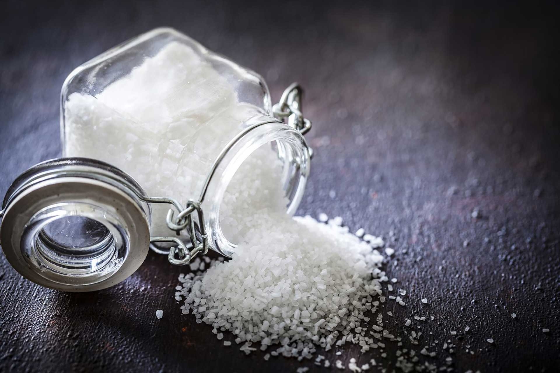 Salt spilled on a table from a salt shaker 