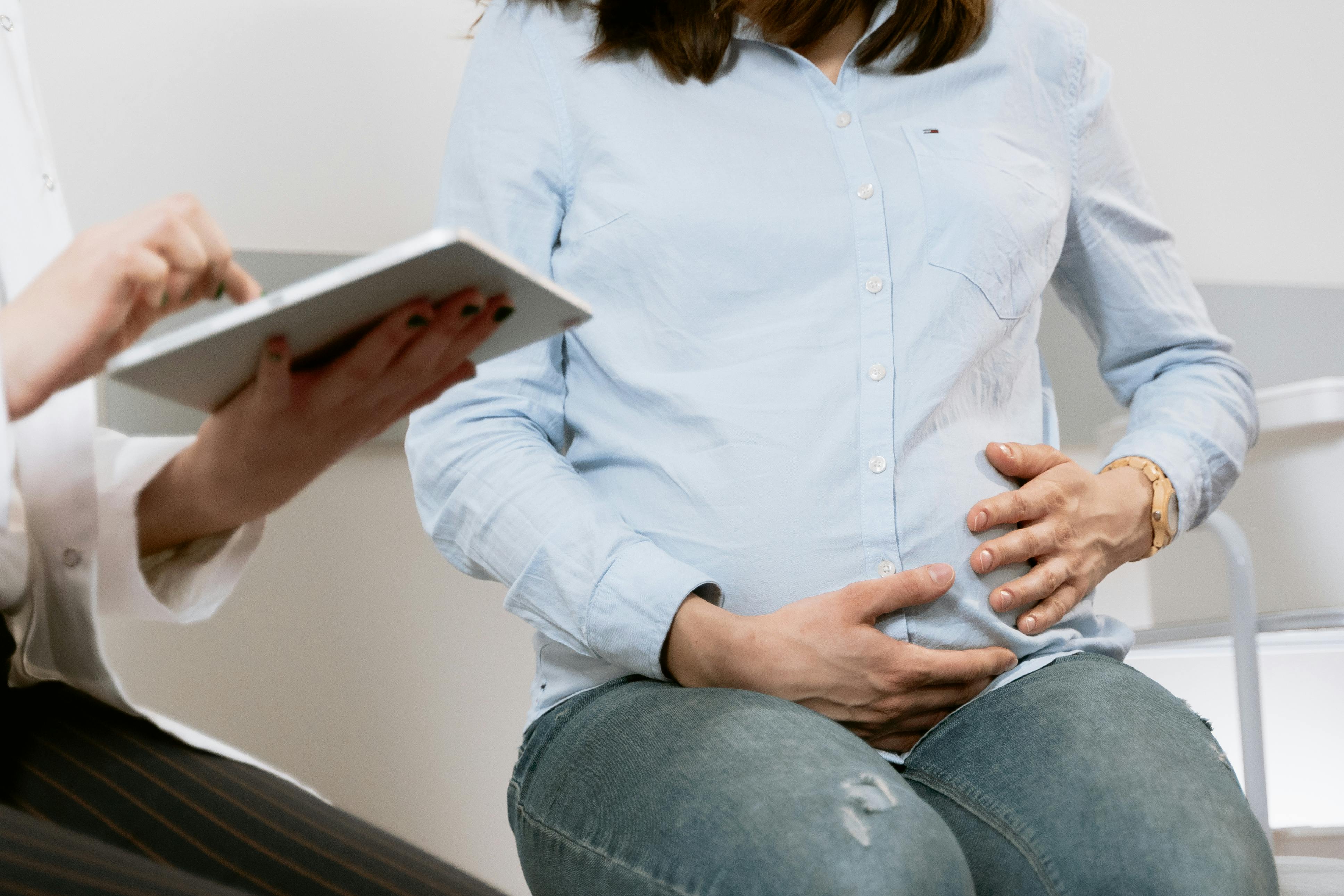 Pregnant woman meeting with health professional